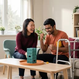 Two people laughing together while playing a stacking game
